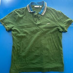 Classic green Lacoste polo shirt with a contrast blue and yellow striped collar